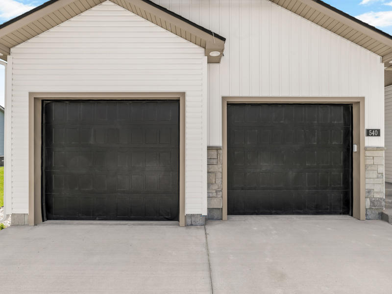 Two black garage doors on a Fox Crossing home